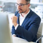 Business person in office thinking